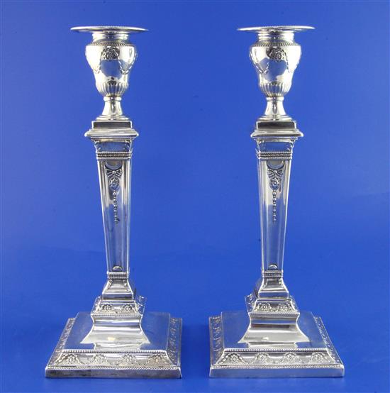 A pair of Victorian Neo-Classical style silver candlesticks, weighted.